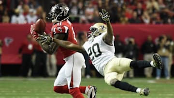 Jan 3, 2016; Atlanta, GA, USA; Atlanta Falcons wide receiver Julio Jones (11) catches a pass defended by New Orleans Saints defensive back Brian Dixon (20) during the fourth quarter at the Georgia Dome. The Saints defeated the Falcons 20-17. Mandatory Credit: Dale Zanine-USA TODAY Sports