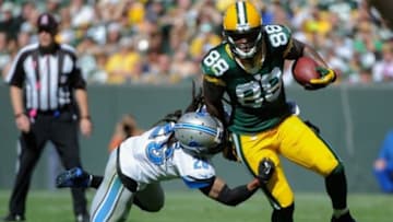 Oct 6, 2013; Green Bay, WI, USA; Green Bay Packers tight end Jermichael Finley (88) is tackled by Detroit Lions safety Louis Delmas (26) in the first quarter at Lambeau Field. Mandatory Credit: Benny Sieu-USA TODAY Sports