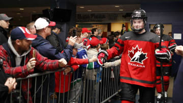 VICTORIA , BC - DECEMBER 19: Alexis Lafrenière #22 of Team Canada high fives with fans prior to a game versus Team Switzerland at the IIHF World Junior Championships at the Save-on-Foods Memorial Centre on December 19, 2018 in Victoria, British Columbia, Canada. Canada defeated Switzerland 5-3. (Photo by Kevin Light/Getty Images)"n"n"n"n