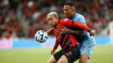 Athletico Paranaense's forward Vitor Roque (L) and Bolivar's defender Jairo Quinteros fight for the ball during the Copa Libertadores round of 16 second leg football match between Brazil's Athletico Paranaense and Bolivia's Bolivar at Ligga Arena in Curitiba, Brazil, on August 8, 2023. (Photo by Albari Rosa / AFP) (Photo by ALBARI ROSA/AFP via Getty Images)