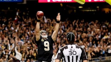 Dec 29, 2013; New Orleans, LA, USA; New Orleans Saints quarterback Drew Brees (9) dunks over the goal post following a touchdown run against the Tampa Bay Buccaneers during the fourth quarter of a game at the Mercedes-Benz Superdome.The Saints defeated the Buccaneers 42-17. Mandatory Credit: Derick E. Hingle-USA TODAY Sports