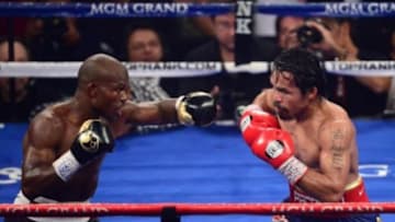 Jun. 9, 2012; Las Vegas, NV, USA; Timothy Bradley Jr (left) against Manny Pacquiao during a welterweight championship bout at the MGM Grand Garden Arena. Mandatory Credit: Mark J. Rebilas-USA TODAY Sports