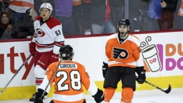 Dec 15, 2015; Philadelphia, PA, USA; Philadelphia Flyers defenseman Shayne Gostisbehere (53) celebrates scoring the game winning goal with center Claude Giroux (28) against the Carolina Hurricanes during overtime at Wells Fargo Center. The Flyers defeated the Hurricanes, 4-3 in overtime. Mandatory Credit: Eric Hartline-USA TODAY Sports