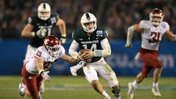 SAN DIEGO, CA - DECEMBER 28: Brian Lewerke #14 of the Michigan State Spartans eludes Dylan Hanser #33 of the Washington State Cougars on a run play during the second half of the SDCCU Holiday Bowl at SDCCU Stadium on December 28, 2017 in San Diego, California. (Photo by Sean M. Haffey/Getty Images)