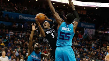 Dec 3, 2016; Charlotte, NC, USA; Minnesota Timberwolves guard Kris Dunn (3) shoots the ball around Charlotte Hornets center Roy Hibbert (55) in the first half at Spectrum Center. Mandatory Credit: Jeremy Brevard-USA TODAY Sports