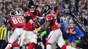LOS ANGELES, CA - JANUARY 06: Quarterback Matt Ryan #2 of the Atlanta Falcons hands offsides to teammate running back Tevin Coleman #26 during the second quarter of the NFC Wild Card Playoff game against the Los Angeles Rams at Los Angeles Coliseum on January 6, 2018 in Los Angeles, California. (Photo by Harry How/Getty Images)
