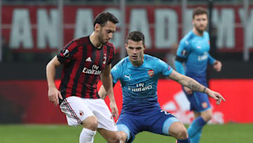 MILAN, ITALY - MARCH 08: Hakan Calhanoglu of AC Milan competes for the ball withGranit Xhaka of Arsenal during UEFA Europa League Round of 16 match between AC Milan and Arsenal at the San Siro on March 8, 2018 in Milan, Italy. (Photo by Marco Luzzani/Getty Images)