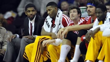 Jan 5, 2014; Cleveland, OH, USA; Cleveland Cavalier injured guard Kyrie Irving (left) sits on the bench in the second quarter against the Indiana Pacers at Quicken Loans Arena. Mandatory Credit: David Richard-USA TODAY Sports