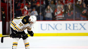 RALEIGH, NORTH CAROLINA - MAY 14: Patrice Bergeron #37 of the Boston Bruins reacts following their 2-3 loss to the Carolina Hurricanes in Game Seven of the First Round of the 2022 Stanley Cup Playoffs at PNC Arena on May 14, 2022 in Raleigh, North Carolina. (Photo by Jared C. Tilton/Getty Images)