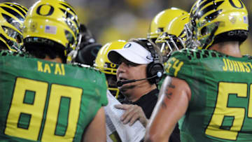 EUGENE, OR - OCTOBER 6: Head coach Chip Kelly of the Oregon Ducks speaks with his team during a timeout during the third quarter of the game against the Washington Huskies on October 6, 2012 at Autzen Stadium in Eugene, Oregon. Oregon won the game 52-21. (Photo by Steve Dykes/Getty Images)