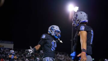 Chandler Wolves cornerback Sammie Hunter (14) and quarterback Dylan Raiola (1) celebrate a forced turnover