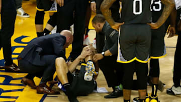 OAKLAND, CALIFORNIA - JUNE 13: Klay Thompson #11 of the Golden State Warriors reacts after hurting his leg against the Toronto Raptors in the second half during Game Six of the 2019 NBA Finals at ORACLE Arena on June 13, 2019 in Oakland, California. NOTE TO USER: User expressly acknowledges and agrees that, by downloading and or using this photograph, User is consenting to the terms and conditions of the Getty Images License Agreement. (Photo by Lachlan Cunningham/Getty Images)