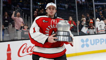 BOSTON, MA - FEBRUARY 13: Devon Levi #1 of the Northeastern Huskies celebrates with the Beanpot trophy after a victory against the Harvard Crimson during NCAA hockey in the championship game of the annual Beanpot Hockey Tournament at TD Garden on February 13, 2023 in Boston, Massachusetts. The game officially ended in a 2-2 tie with the Huskies winning the shootout 1-0 to capture the title. (Photo by Richard T Gagnon/Getty Images)