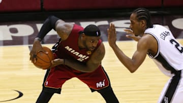 LeBron James #6 of the Miami Heat holds the ball away from Kawhi Leonard #2 of the San Antonio Spurs (Photo by Chris Covatta/Getty Images)