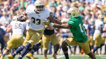 Apr 16, 2016; South Bend, IN, USA; Notre Dame Fighting Irish running back Josh Adams (33) is tackled by cornerback Shaun Crawford (14) in the second quarter of the Blue-Gold Game at Notre Dame Stadium. Mandatory Credit: Matt Cashore-USA TODAY Sports