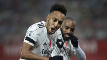 MANCHESTER, ENGLAND - NOVEMBER 01: Pierre-Emerick Aubameyang of Arsenal celebrates scoring with team mate Alexandre Lacazette during the Premier League match between Manchester United and Arsenal at Old Trafford on November 1, 2020 in Manchester, United Kingdom. Sporting stadiums around the UK remain under strict restrictions due to the Coronavirus Pandemic as Government social distancing laws prohibit fans inside venues resulting in games being played behind closed doors. (Photo by Visionhaus)