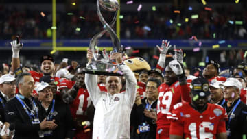 ARLINGTON, TX - DECEMBER 29: Head coach Urban Meyer of the Ohio State Buckeyes holds up the Cotton Bowl trophy following the 82nd Goodyear Cotton Bowl Classic between USC and Ohio State at AT