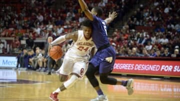 Jan 9, 2016; Norman, OK, USA; Oklahoma Sooners guard Buddy Hield (24) drives to the basket in front of Kansas State Wildcats guard Barry Brown (5) during the second half at Lloyd Noble Center. Mandatory Credit: Mark D. Smith-USA TODAY Sports