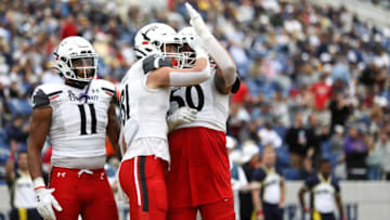 Josh Whyle celebrates with the team after scoring a touchdown. The Enquirer.