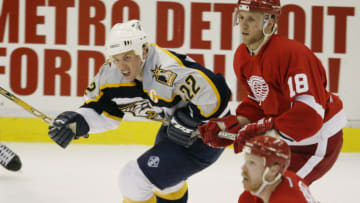 DETROIT - APRIL 15: Kirk Maltby #18 of the Detroit Red Wings defends Greg Johnson #22 of the Nashville Predators during the third period of game five of the first round of the Stanley Cup Playoffs at Joe Louis Arena on April 15, 2004 in Detroit, Michigan. The Red Wings won the game 4-1, giving them a 3-2 lead in the best-of-seven series. (Photo by Tom Pidgeon/Getty Images)