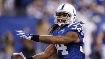 Dec 15, 2013; Indianapolis, IN, USA; Indianapolis Colts running back Trent Richardson (34) spikes the ball after scoring a touchdown against the Houston Texans at Lucas Oil Stadium. Mandatory Credit: Brian Spurlock-USA TODAY Sports