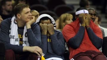Jan 23, 2015; Cleveland, OH, USA; Cleveland Cavaliers center Timofey Mozgov (20), Cleveland Cavaliers guard J.R. Smith (5) and Cleveland Cavaliers forward LeBron James (23) laugh on the bench during the fourth quarter against the Charlotte Hornets at Quicken Loans Arena. The Cavs won 129-90. Mandatory Credit: Ken Blaze-USA TODAY Sports