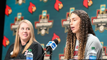 Dec 14, 2022; Omaha, Nebraska, US; Louisville Cardinals Amaya Tillman (25) answers questions as head coach Dani Busboom Kelly looks on at the press conference at CHI Health Center. Mandatory Credit: Steven Branscombe-USA TODAY Sports