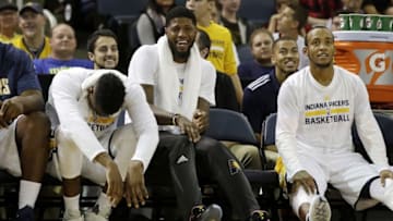 Oct 12, 2016; Evansville, IN, USA; Indiana Pacers forward Paul George (center) shares a laugh from the bench with teammates during a game against the Milwaukee Bucks at Ford Center. Mandatory Credit: James Brosher-USA TODAY Sports