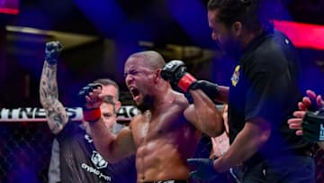 Jan 22, 2022; Anaheim, California, USA; Tony Gravely (red gloves) celebrates his win by unanimous decision against Saimon Oliveira (blue gloves) during UFC 270 at Honda Center. Mandatory Credit: Gary A. Vasquez-USA TODAY Sports