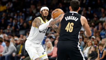 Nov 10, 2023; Memphis, Tennessee, USA; Utah Jazz guard Jordan Clarkson (0) attempts a three point shot as Memphis Grizzlies guard John Konchar (46) defends during the second half at FedExForum. Mandatory Credit: Petre Thomas-USA TODAY Sports