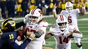 Nov 14, 2020; Ann Arbor, Michigan, USA; Wisconsin Badgers running back Nakia Watson (14) rushes for a touchdown in the first half against the Michigan Wolverines at Michigan Stadium. Mandatory Credit: Rick Osentoski-USA TODAY Sports