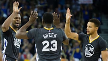 Dec 17, 2016; Oakland, CA, USA; Golden State Warriors forward Kevin Durant (35), forward Draymond Green (23) and guard Stephen Curry (30) high five after a play against the Portland Trail Blazers during the third quarter at Oracle Arena. The Golden State Warriors defeated the Portland Trail Blazers 135-90. Mandatory Credit: Kelley L Cox-USA TODAY Sports