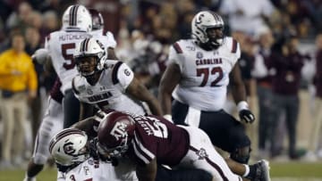 COLLEGE STATION, TEXAS - NOVEMBER 16: Ryan Hilinski #3 of the South Carolina Gamecocks takes a hit from Justin Madubuike #52 of the Texas A&M Aggies during the second half at Kyle Field on November 16, 2019 in College Station, Texas. (Photo by Bob Levey/Getty Images)
