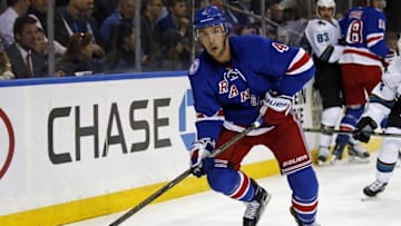 Oct 17, 2016; New York, NY, USA; New York Rangers defenseman Adam Clendening (4) looks to pass the puck against the San Jose Sharks during the first period at Madison Square Garden. Mandatory Credit: Adam Hunger-USA TODAY Sports