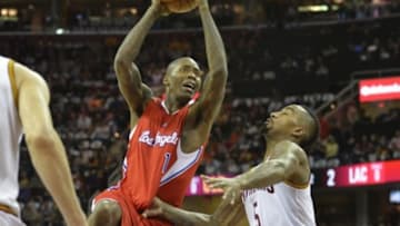 Feb 5, 2015; Cleveland, OH, USA; Los Angeles Clippers guard Jamal Crawford (11) drives against Cleveland Cavaliers guard J.R. Smith (5) in the first quarter at Quicken Loans Arena. Mandatory Credit: David Richard-USA TODAY Sports