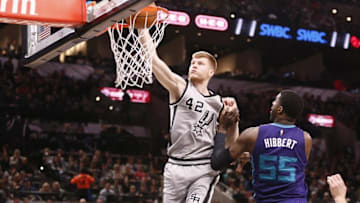 Jan 7, 2017; San Antonio, TX, USA; San Antonio Spurs small forward Davis Bertans (42) dunks the ball against Charlotte Hornets center Roy Hibbert (55) during the first half at AT&T Center. Mandatory Credit: Soobum Im-USA TODAY Sports