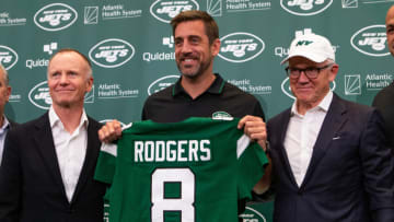 Apr 26, 2023; Florham Park, NJ, USA; New York Jets quarterback Aaron Rodgers (8) (center) poses for a photo with New York Jets owners Christopher Johnson (left) Woody Johnson (right) during the introductory press conference at Atlantic Health Jets Training Center. Mandatory Credit: Tom Horak-USA TODAY Sports