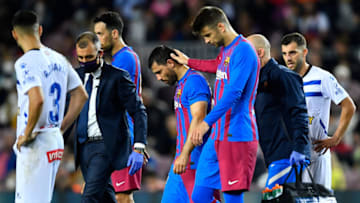 Barcelona's Spanish defender Gerard Pique (CR) caresses Barcelona's Argentinian forward Kun Aguero (CL). (Photo by PAU BARRENA/AFP via Getty Images)