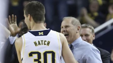 Dec 22, 2014; Ann Arbor, MI, USA; Michigan Wolverines guard Austin Hatch (30) receives congratulations from head coach John Beilein in the second half against the Coppin State Eagles at Crisler Center. Michigan won 72-56. Mandatory Credit: Rick Osentoski-USA TODAY Sports