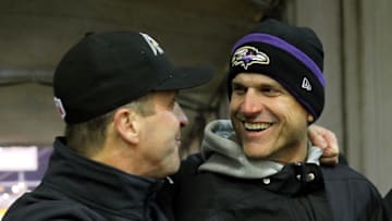 PITTSBURGH, PA - JANUARY 03: Michigan coach Jim Harbaugh (R) celebrates with his brother, head coach John Harbaugh (L) of the Baltimore Ravens after the Ravens defeated the Pittsburgh Steelers 30-17 in their AFC Wild Card game at Heinz Field on January 3, 2015 in Pittsburgh, Pennsylvania. (Photo by Jamie Squire/Getty Images)