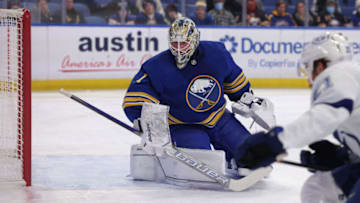 Jan 11, 2022; Buffalo, New York, USA; Buffalo Sabres goaltender Ukko-Pekka Luukkonen (1) looks for the loose puck during the first period against the Tampa Bay Lightning at KeyBank Center. Mandatory Credit: Timothy T. Ludwig-USA TODAY Sports