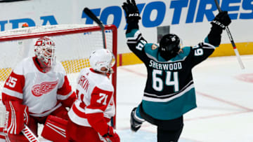 ANAHEIM, CA - OCTOBER 8: Kiefer Sherwood #64 of the Anaheim Ducks celebrates a goal in the second period against Jimmy Howard #35 and Dylan Larkin #71 of the Detroit Red Wings during the game on October 8, 2018 at Honda Center in Anaheim, California. (Photo by Debora Robinson/NHLI via Getty Images)