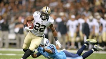 Aug 15, 2014; New Orleans, LA, USA; New Orleans Saints running back Mark Ingram (22) carries the ball past Tennessee Titans free safety George Wilson (21) on his way to scoring a touchdown in the second quarter at Mercedes-Benz Superdome. Mandatory Credit: Crystal LoGiudice-USA TODAY Sports