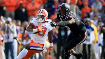 COLUMBIA, SOUTH CAROLINA - NOVEMBER 30: Aaron Sterling #15 of the South Carolina Gamecocks tries to stop Travis Etienne #9 of the Clemson Tigers during their game at Williams-Brice Stadium on November 30, 2019 in Columbia, South Carolina. (Photo by Streeter Lecka/Getty Images)