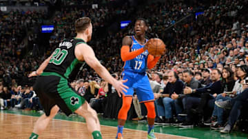 OKC Thunder's Dennis Schroder #17 looks to pass the ball against Gordon Hayward #20. (Photo by Brian Babineau/NBAE via Getty Images)