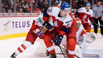 VANCOUVER, BC - DECEMBER 28: Filip Zadina #19 of the Czech Republic tries to protect the puck while Alexander Alexeyev #4 of Russia defends in Group A hockey action of the 2019 IIHF World Junior Championship action on December, 28, 2018 at Rogers Arena in Vancouver, British Columbia, Canada. (Photo by Rich Lam/Getty Images)