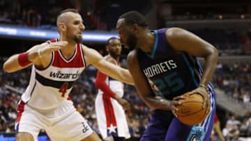 Oct 17, 2014; Washington, DC, USA; Charlotte Hornets center Al Jefferson (25) holds the ball as Washington Wizards center Marcin Gortat (4) defends in the second quarter at Verizon Center. The Hornets won 96-86. Mandatory Credit: Geoff Burke-USA TODAY Sports