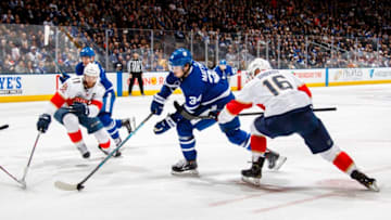 TORONTO, ON - MARCH 25: Auston Matthews #34 of the Toronto Maple Leafs battles with Jonathan Huberdeau #11 and Aleksander Barkov #16 of the Florida Panthers during the second period at the Scotiabank Arena on March 25, 2019 in Toronto, Ontario, Canada. (Photo by Mark Blinch/NHLI via Getty Images)