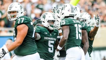 Michigan State's Nathan Carter, center, celebrates with teammates after his third touchdown run in the third quarter against Richmond on Saturday, Sept. 9, 2023, at Spartan Stadium in East Lansing.