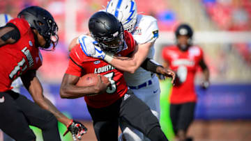 Dec 28, 2021; Dallas, Texas, USA; Louisville Cardinals quarterback Malik Cunningham (3) is tackled by the Air Force Falcons defense during the first half during the 2021 First Responder Bowl at Gerald J. Ford Stadium. Mandatory Credit: Jerome Miron-USA TODAY Sports